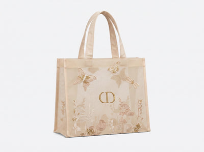 Beige Dior mesh tote bag with embroidered butterflies and double handles, shown with small zipped pouch
