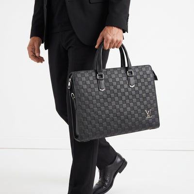 Louis Vuitton Damier Graphite slim briefcase with top handles and silver LV logo.