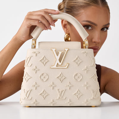 Cream Louis Vuitton top-handle bag with LV logo and monogram appliqué