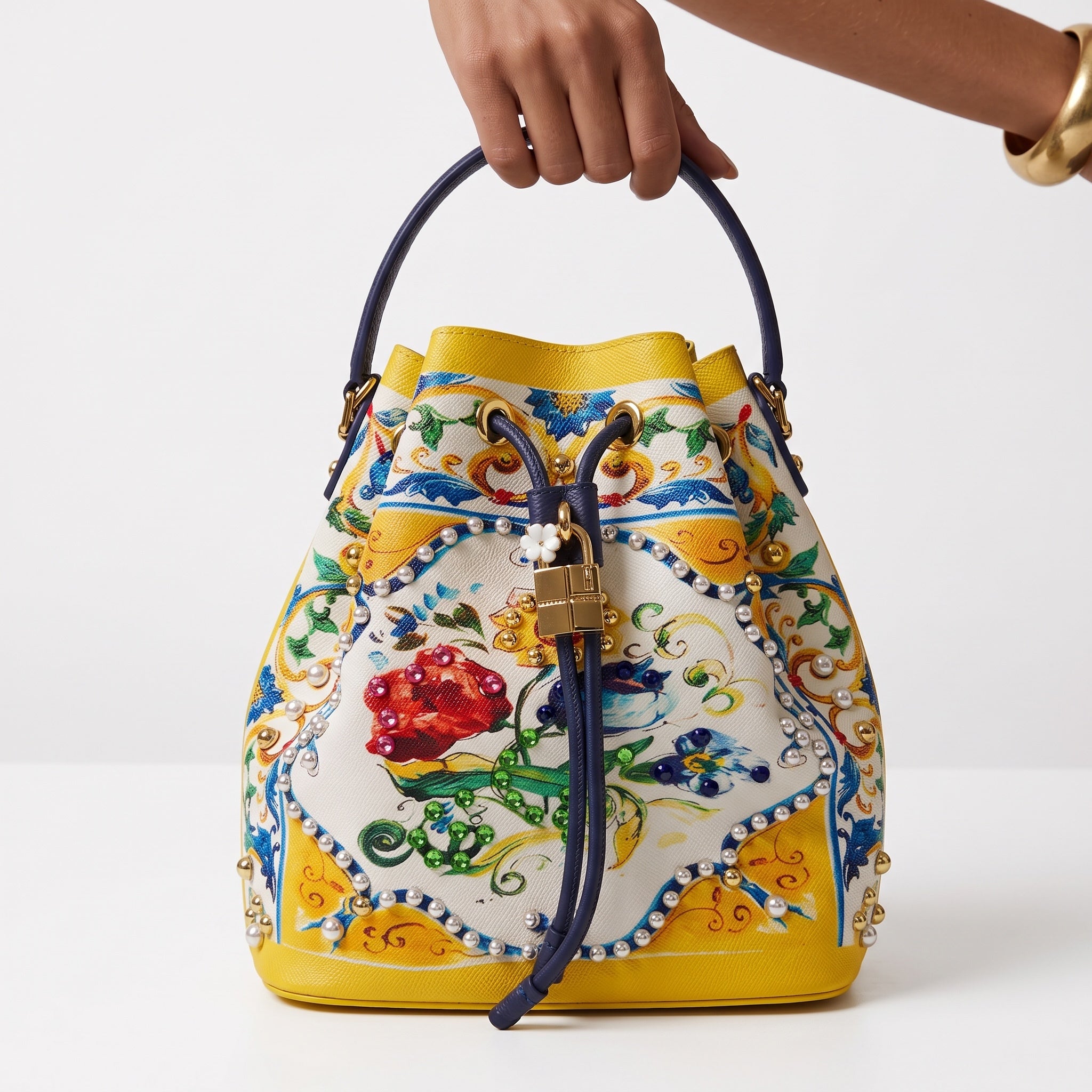Yellow floral drawstring bucket bag with gold padlock and stud detailing
