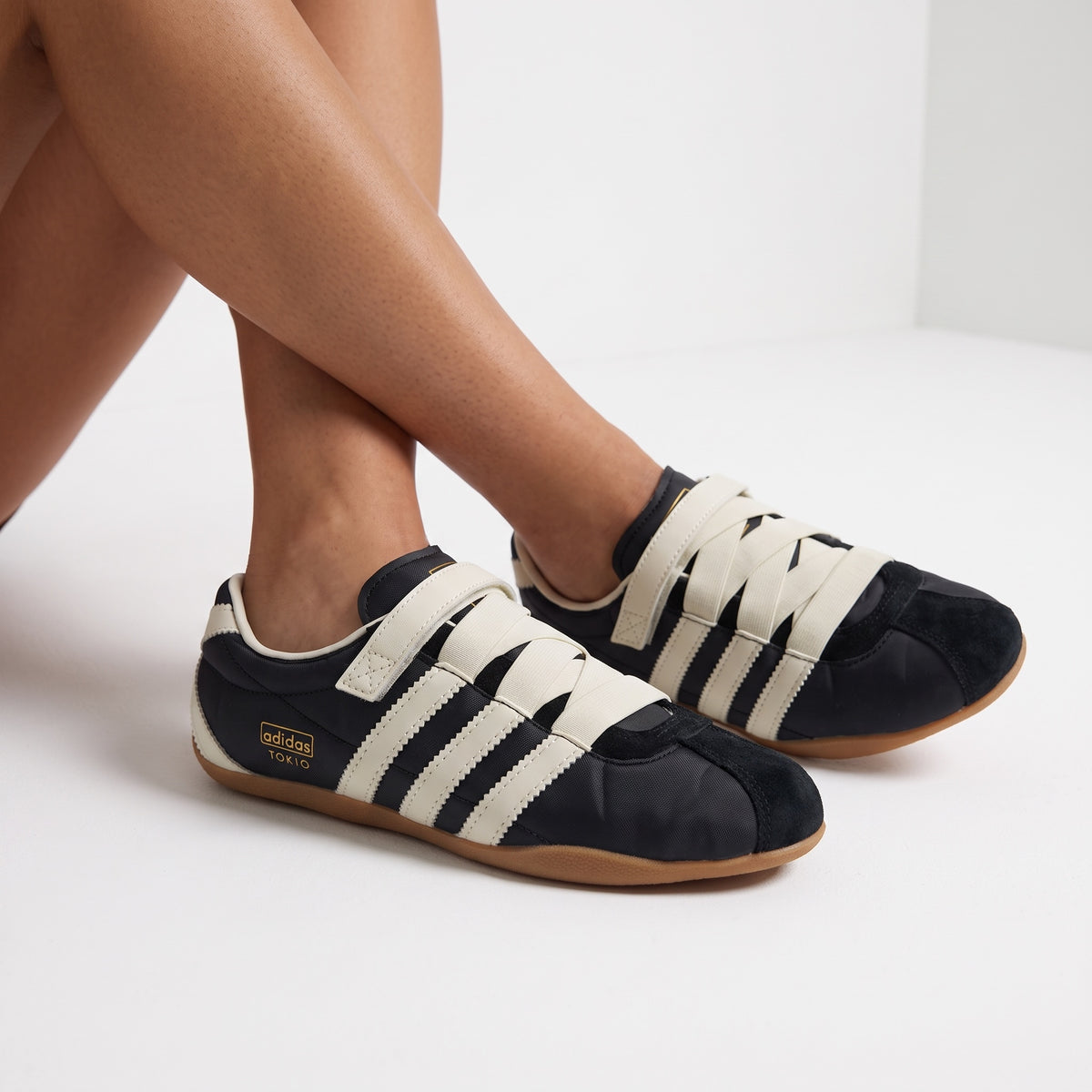 adidas Tokio black trainers with cream stripes and gum sole