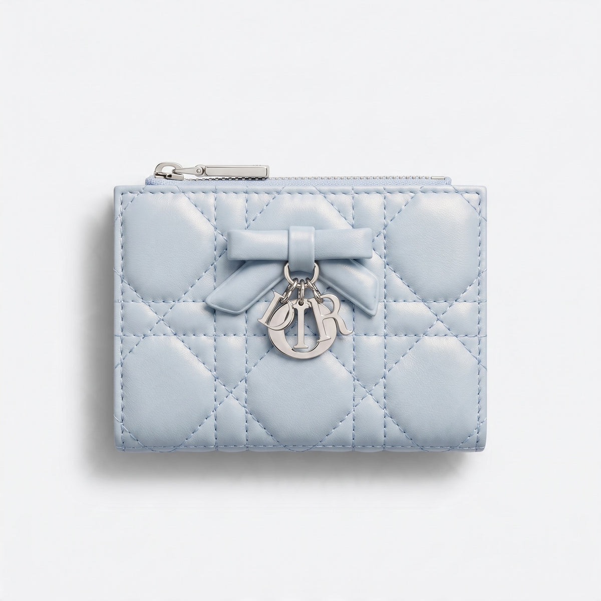 Light blue quilted Dior wallet with bow and silver Dior letter charms, top zip