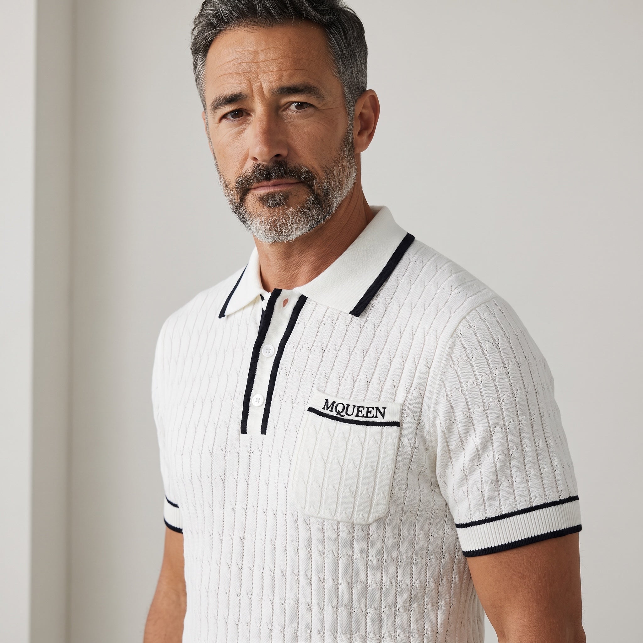 White Alexander McQueen short-sleeve knit polo with navy trim and chest pocket embroidered MCQUEEN