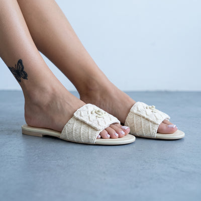 Ivory Chanel crochet slide mule with CC logo on vamp shown on model feet