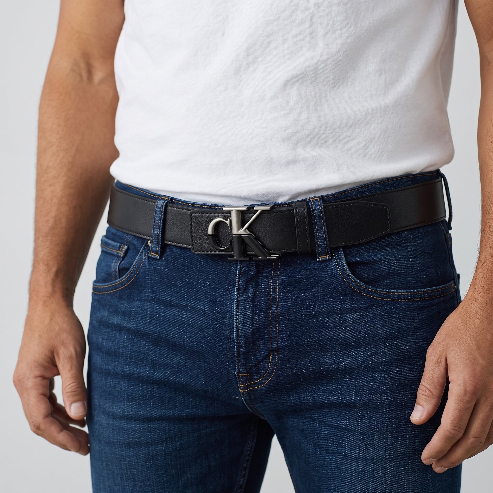 Black Calvin Klein belt with CK metal buckle on jeans