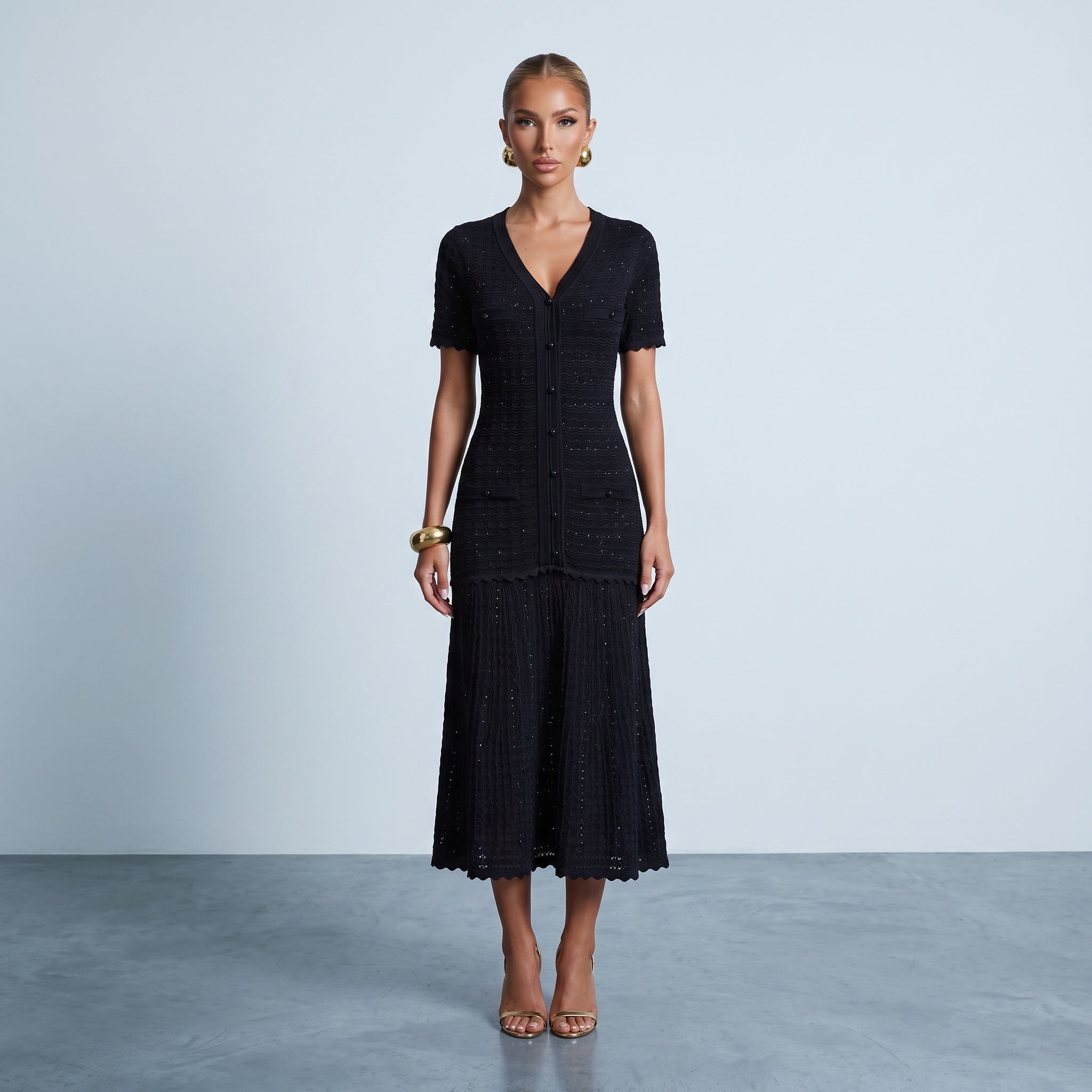 Black knit midi dress with button front, scalloped edges and textured wave pattern