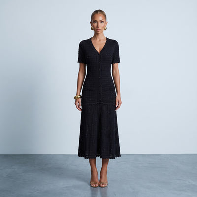 Black knit midi dress with button front, scalloped edges and textured wave pattern