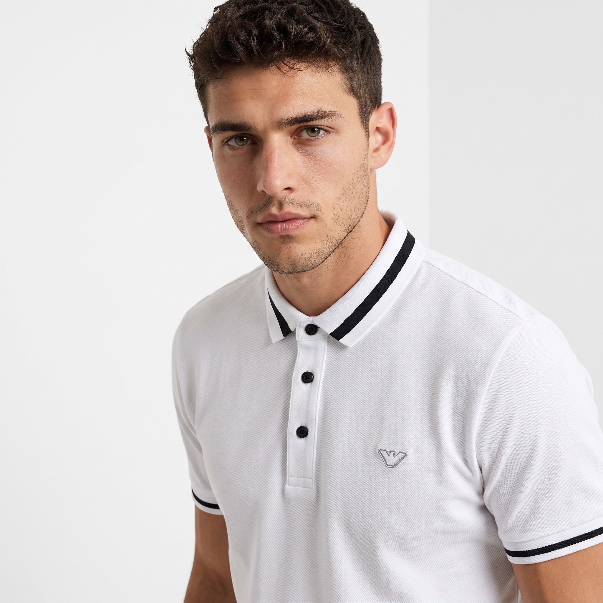 White Emporio Armani polo with black collar and sleeve trim, embroidered logo