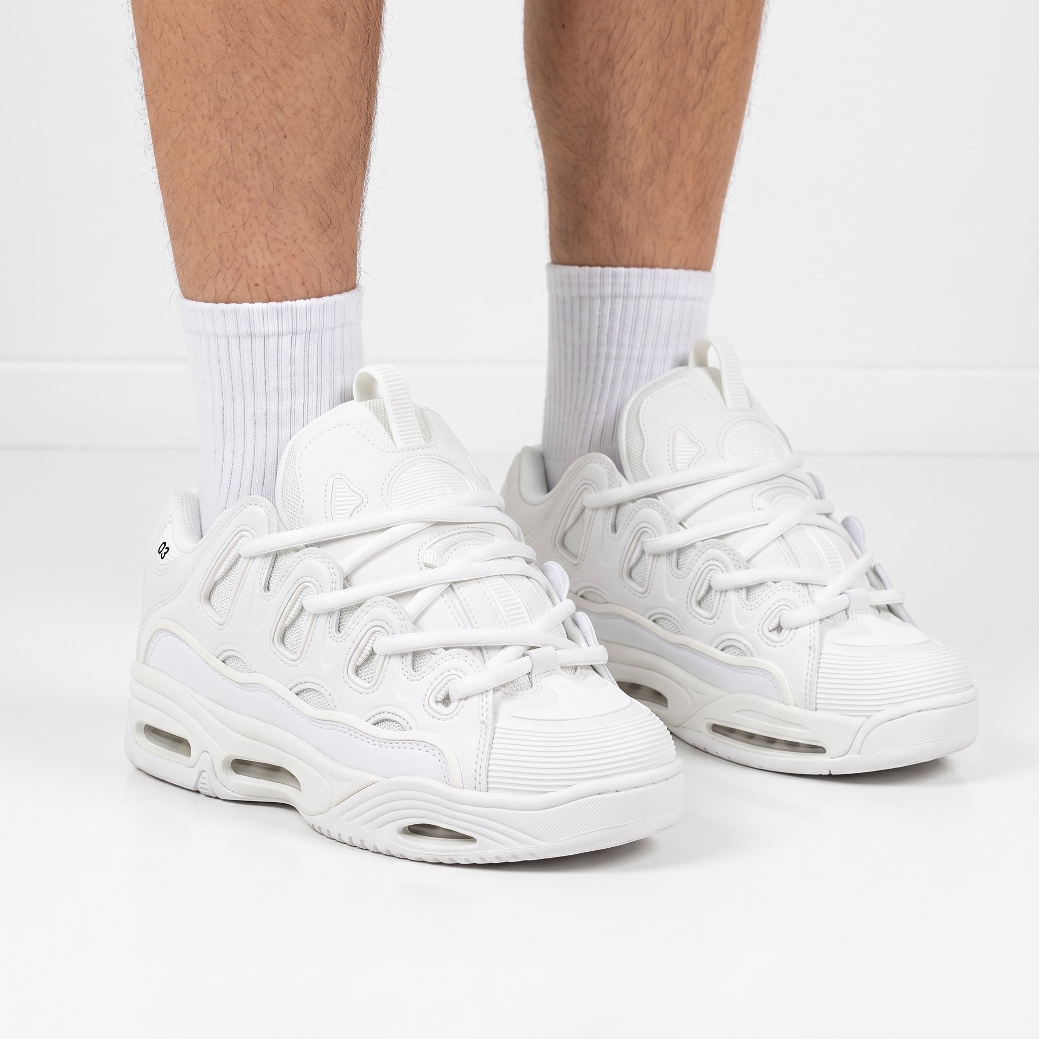 All‑white Osiris D3 chunky sneakers with layered upper and visible sole windows