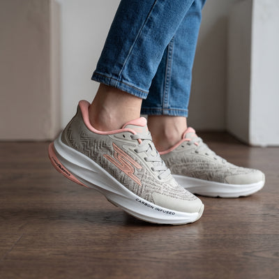 light grey Skechers lace-up sneakers with pink accents and thick white midsole