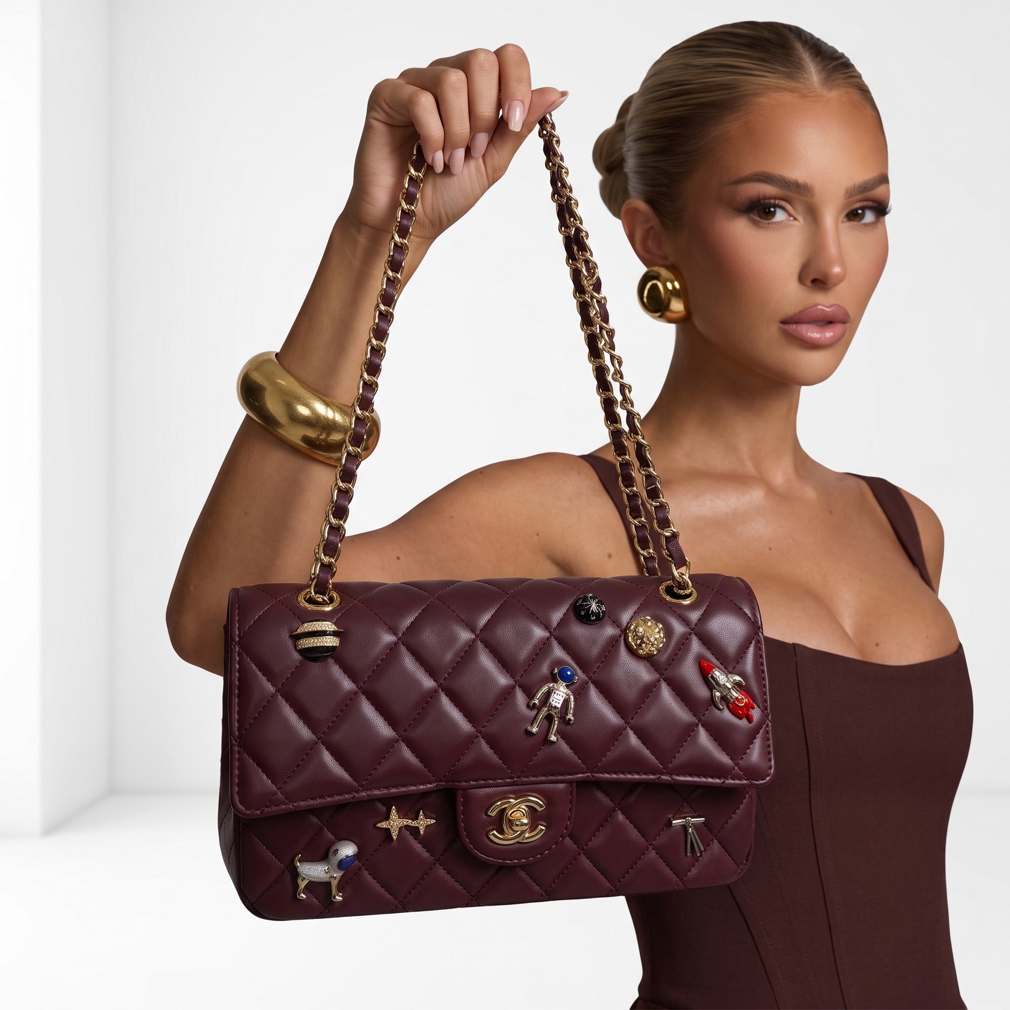 Chanel burgundy quilted flap shoulder bag with gold chain strap and charm pins