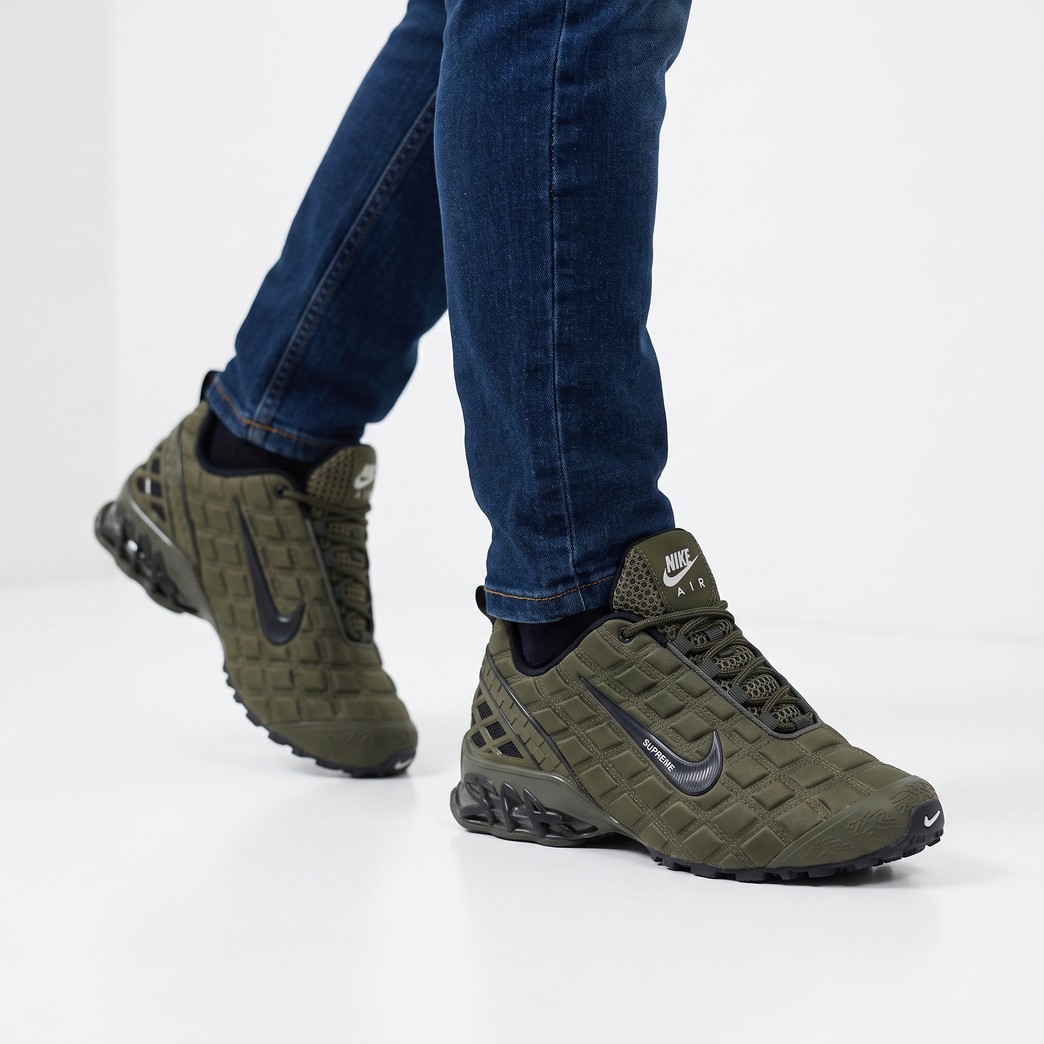 olive green Nike AirMax-style sneakers with black swoosh