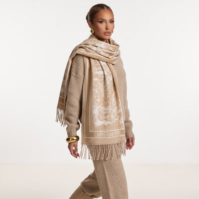 Beige and ivory Dior logo jacquard scarf with fringe wrapped around model