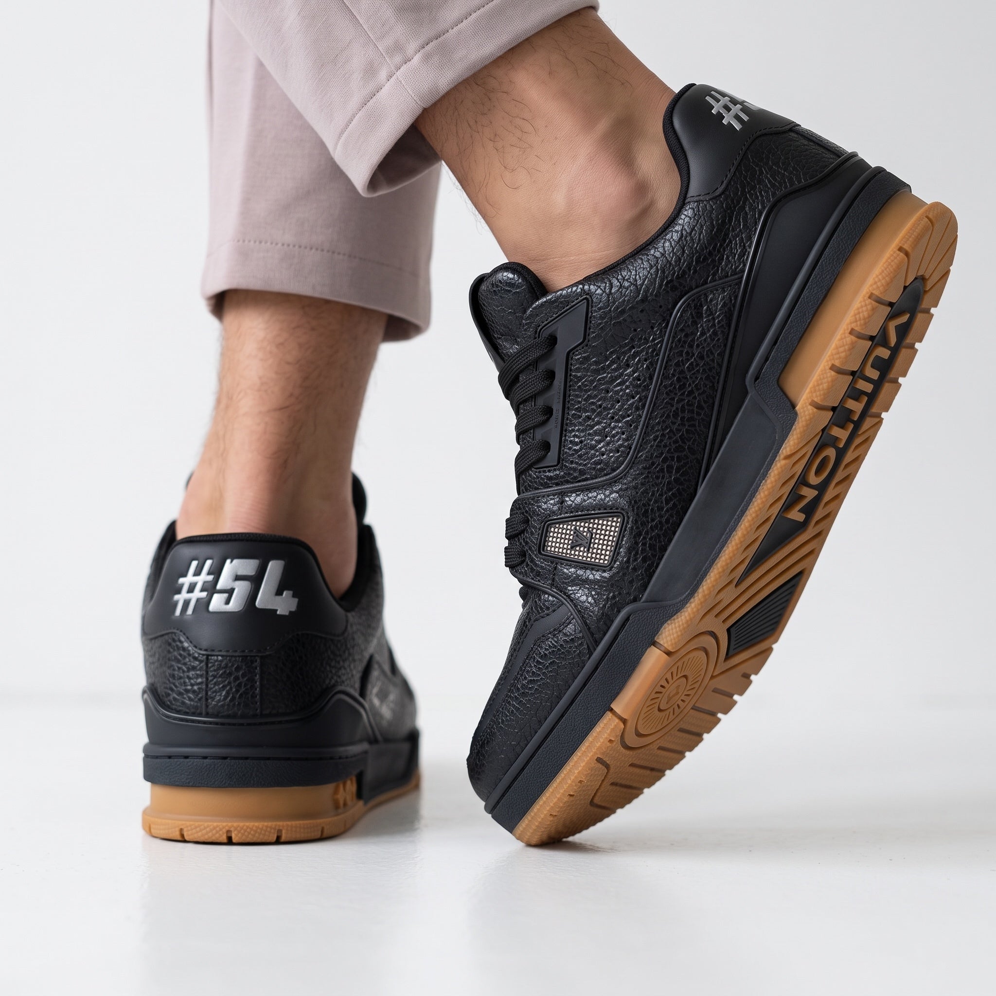 Black Louis Vuitton low-top trainer with gum sole and textured upper
