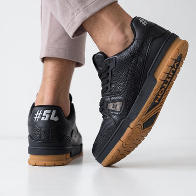 Black Louis Vuitton low-top trainer with gum sole and textured upper