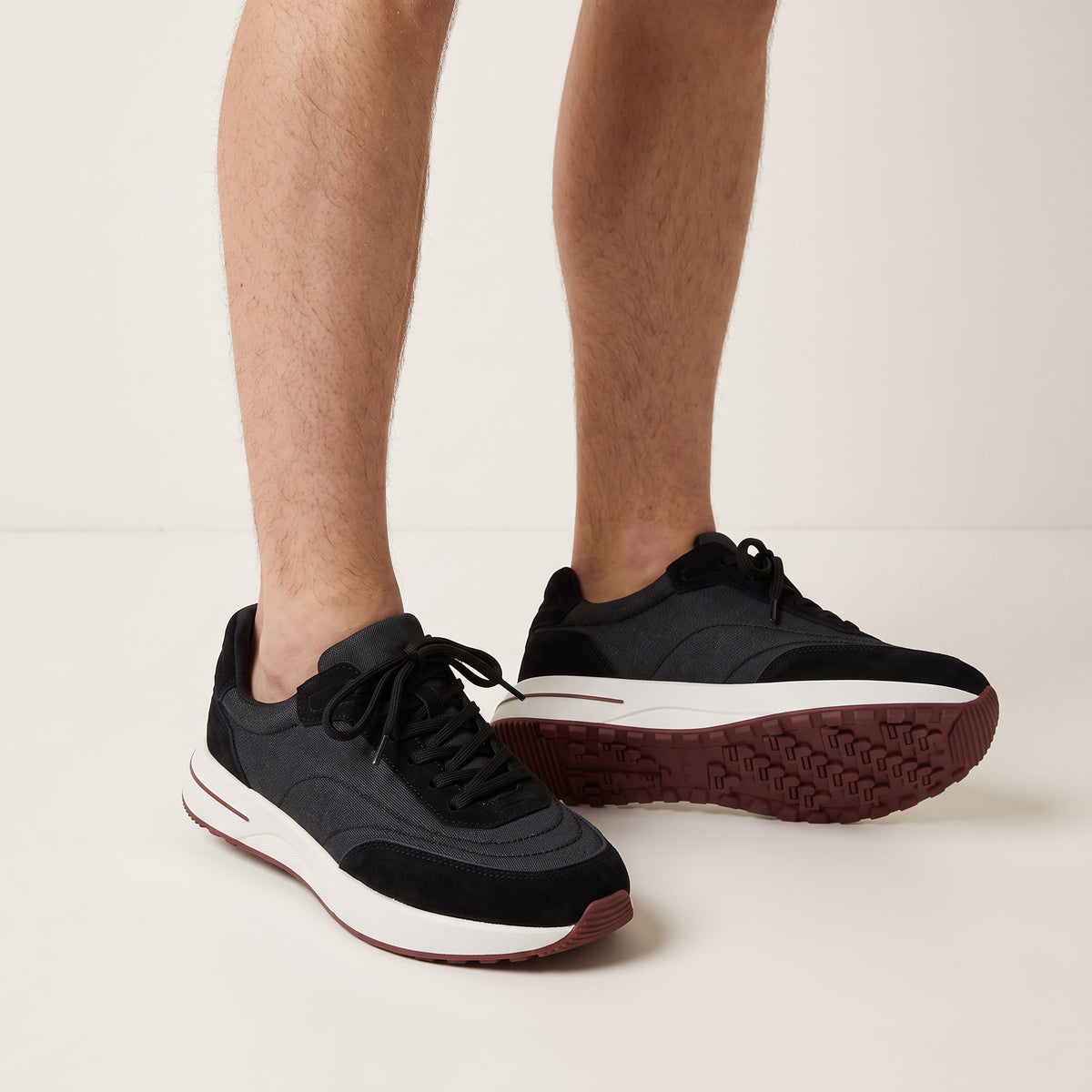navy low-top sneakers with white midsole and maroon tread