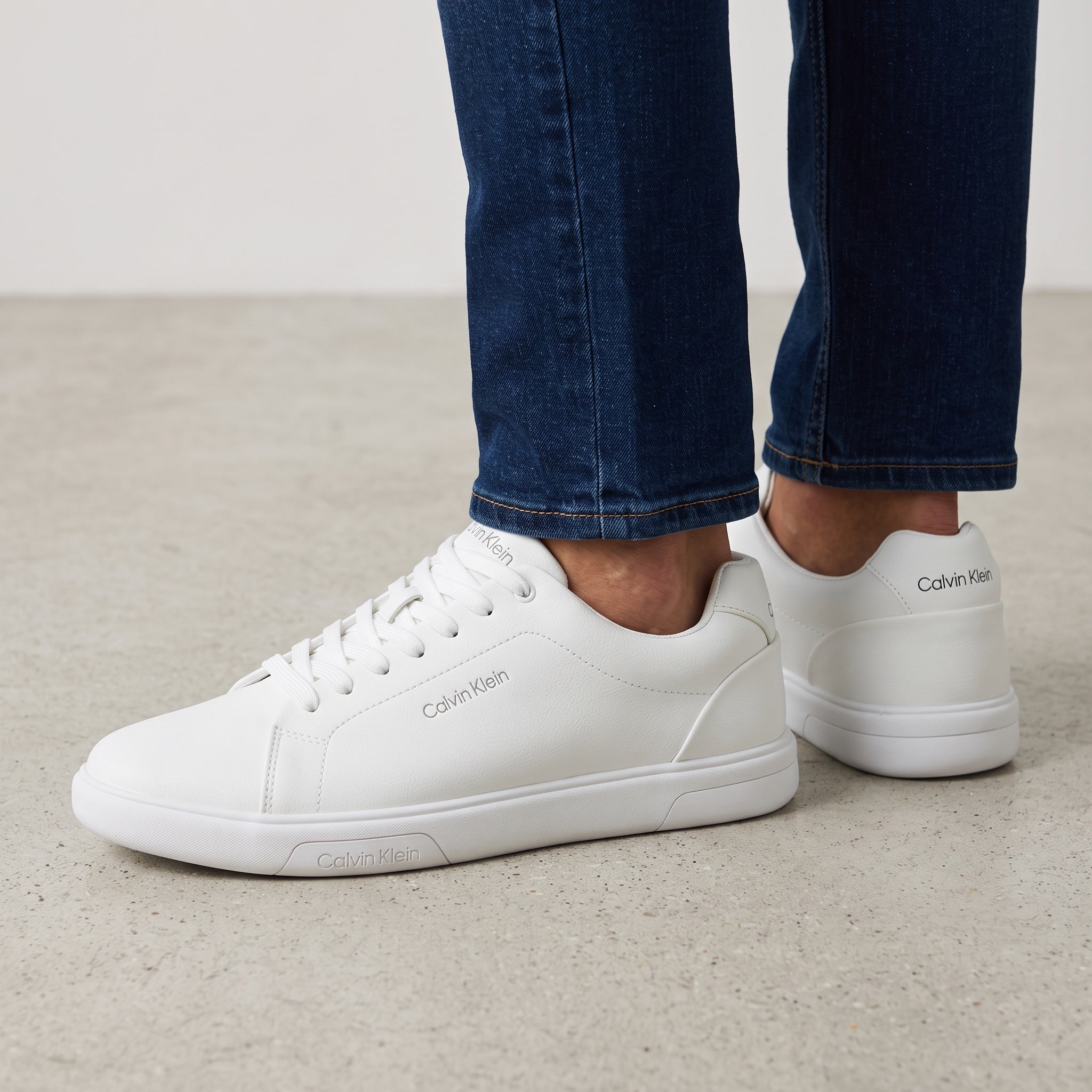 Calvin Klein white low-top sneakers with rubber sole and subtle branding