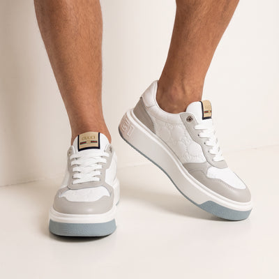 White and grey Gucci platform low-top sneaker with embossed GG and branded tongue