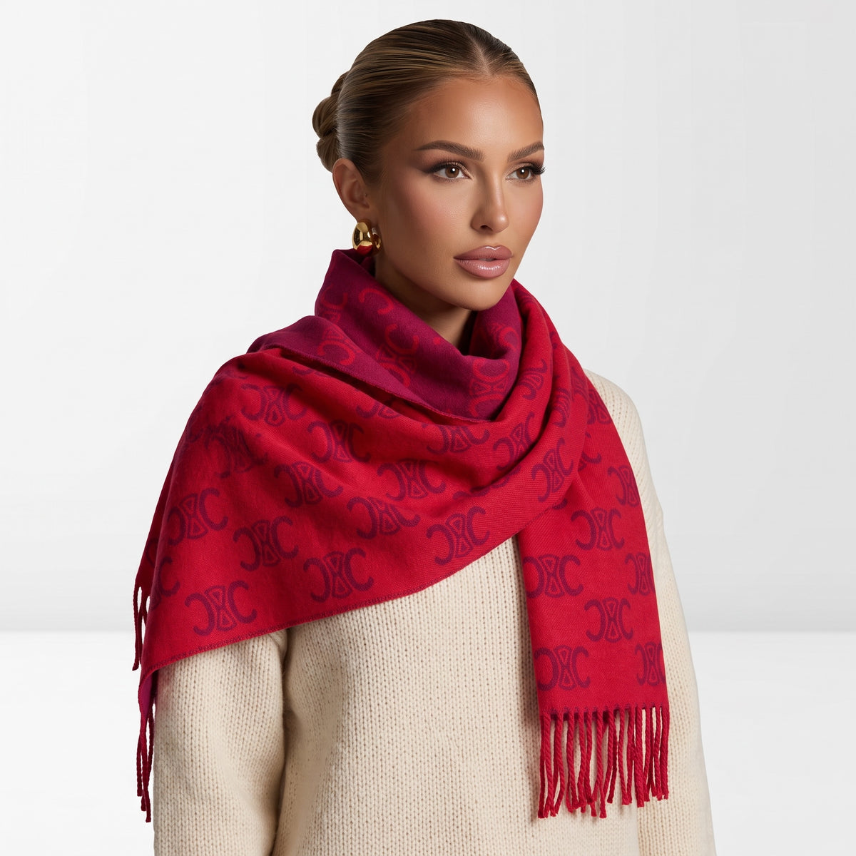 Red Celine Triomphe jacquard scarf draped over shoulders with fringed ends
