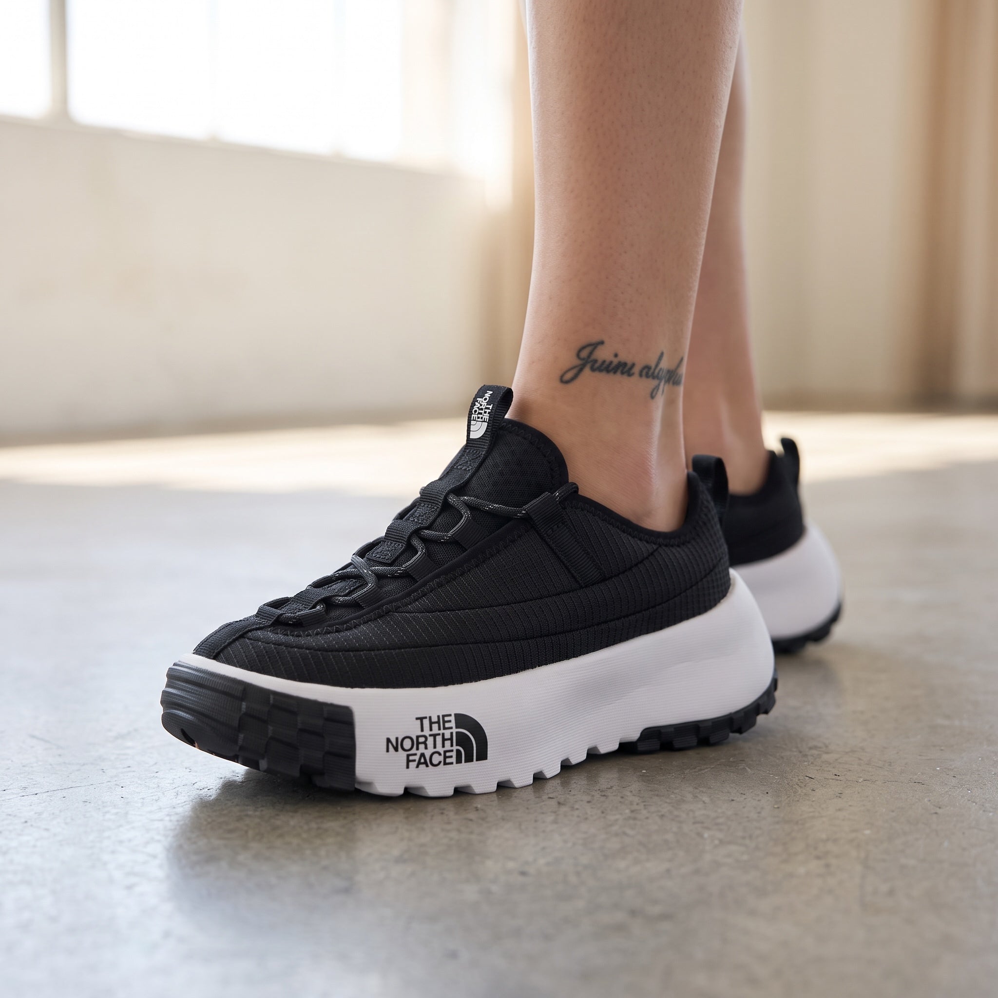 The North Face black platform trail runner with white chunky midsole and lugged outsole