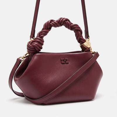GANNI wine top-handle bag with braided knot handle and shoulder strap