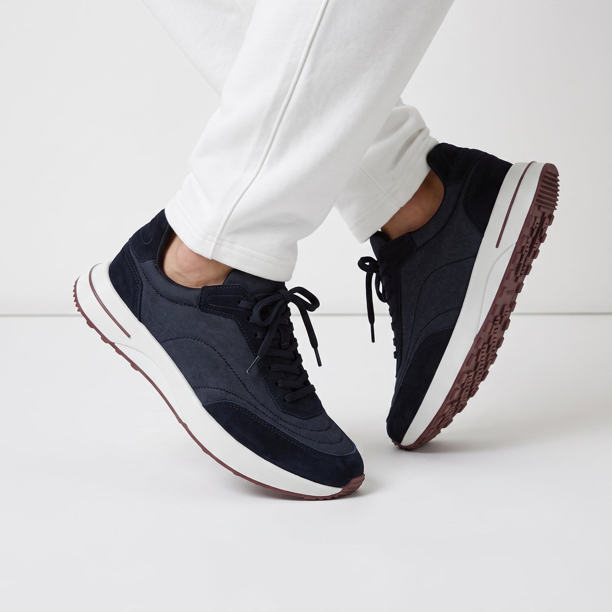 navy low-top sneakers with white midsole and maroon tread