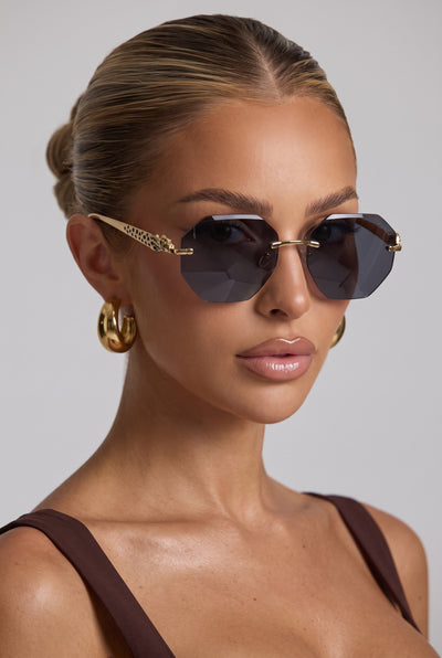 Cartier rimless octagon sunglasses with dark brown lenses and gold-tone panther temple details