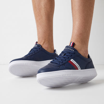 navy Tommy Hilfiger low-top sneaker with white sole and red stripe