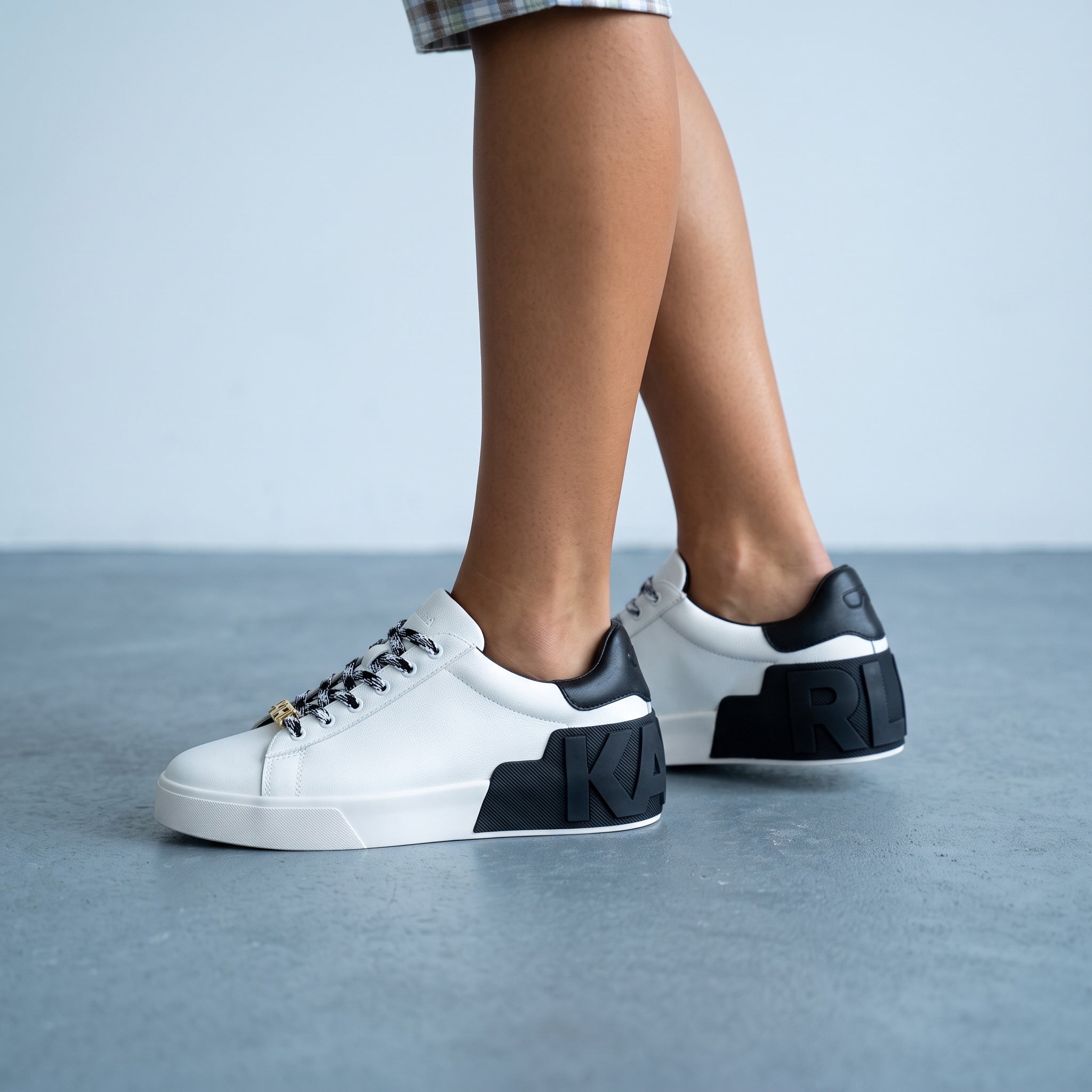 white Karl Lagerfeld low-top sneakers with black heel and KARL logo