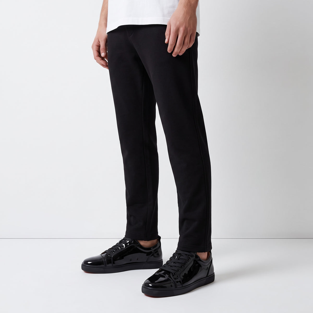 black patent low-top sneakers with red sole