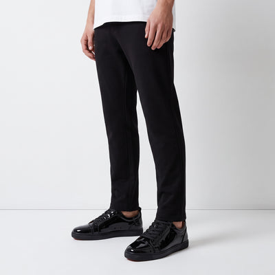 black patent low-top sneakers with red sole