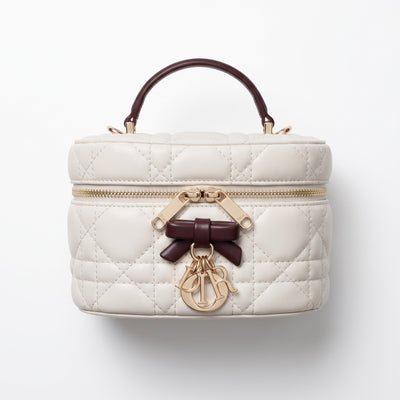 Dior cream quilted vanity bag with burgundy handle and gold charms