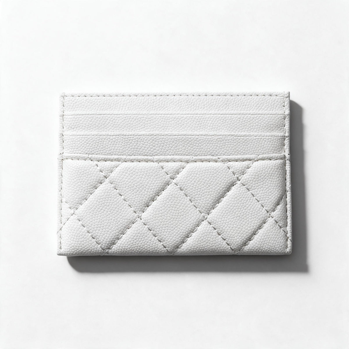 white quilted Chanel card holder with gold CC logo and multiple card slots