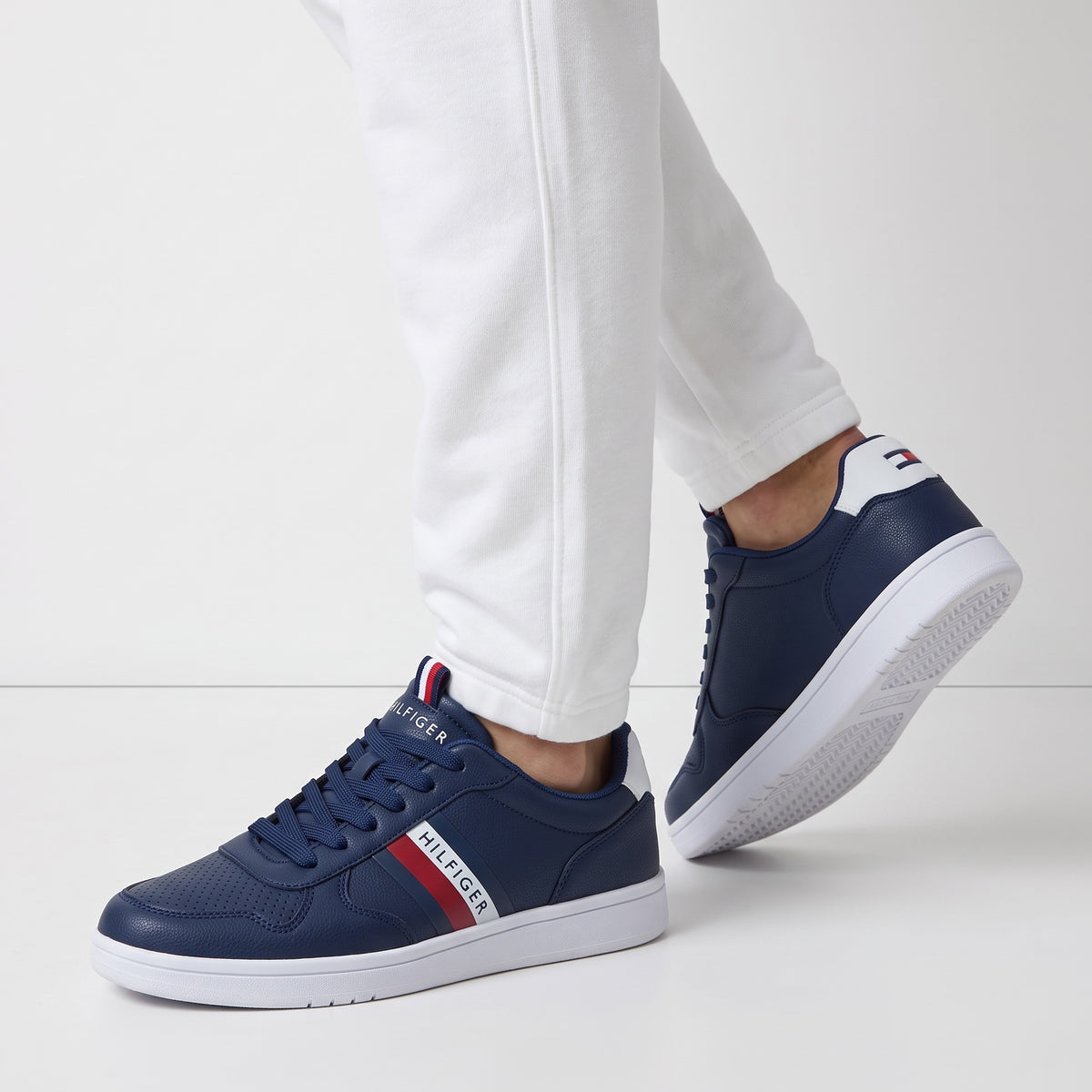 navy Tommy Hilfiger low-top sneaker with white sole and red stripe