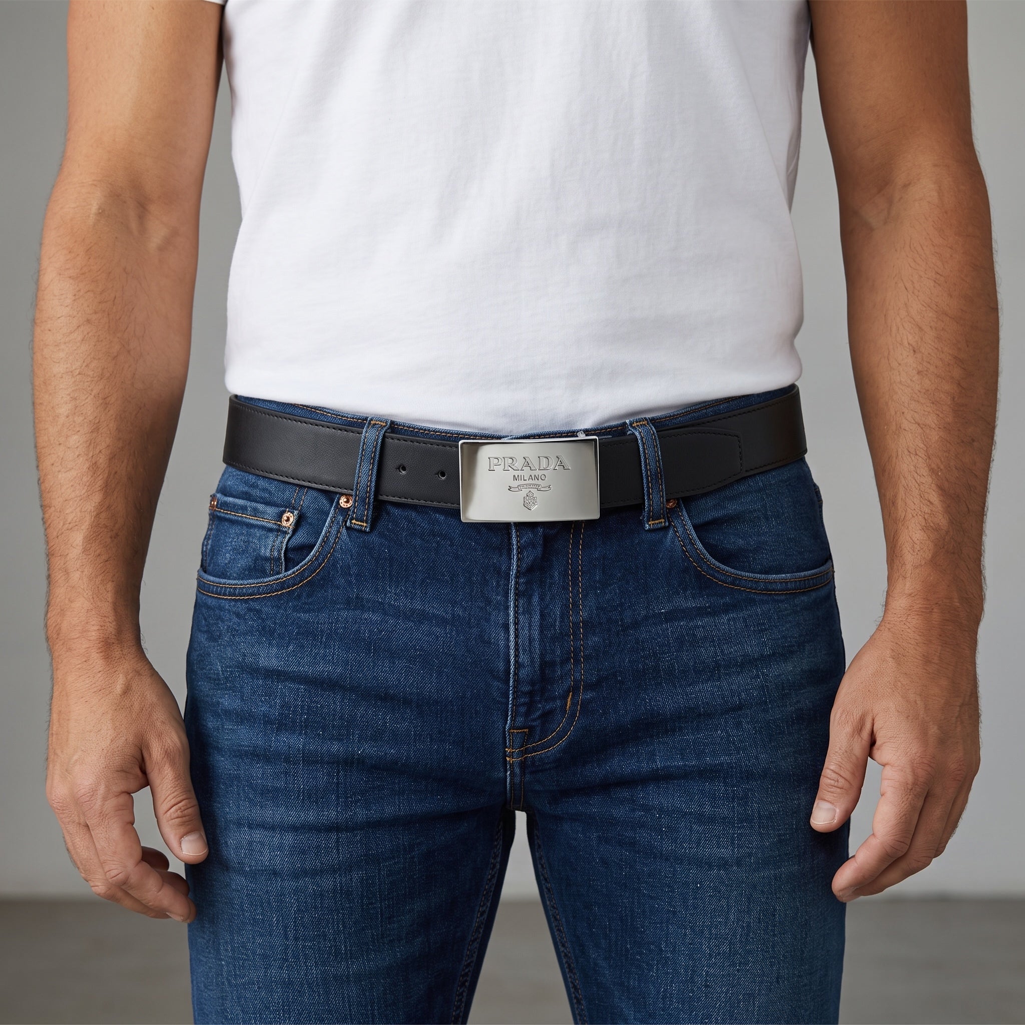 Black Prada belt with silver rectangular plaque buckle worn with jeans