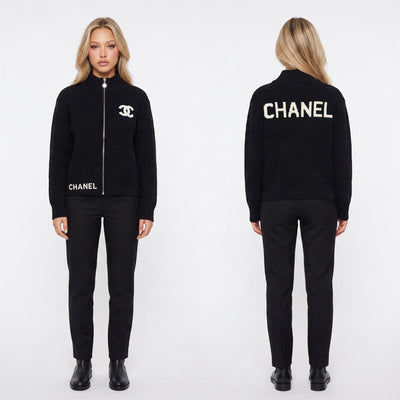 Black Chanel ribbed zip cardigan with white CC logo on chest and CHANEL lettering on back