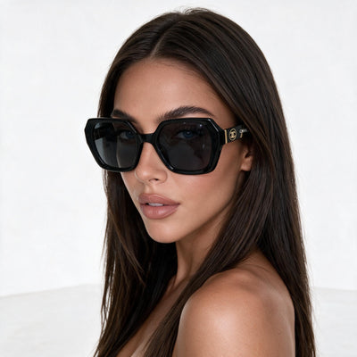 Chanel oversized black sunglasses with gold CC logo on temple
