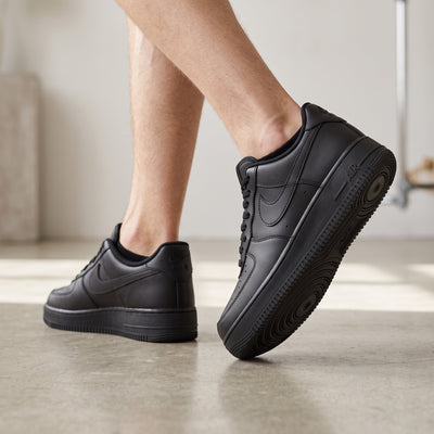 all-black Nike Air Force 1 low-top sneaker with tonal Swoosh and AIR midsole