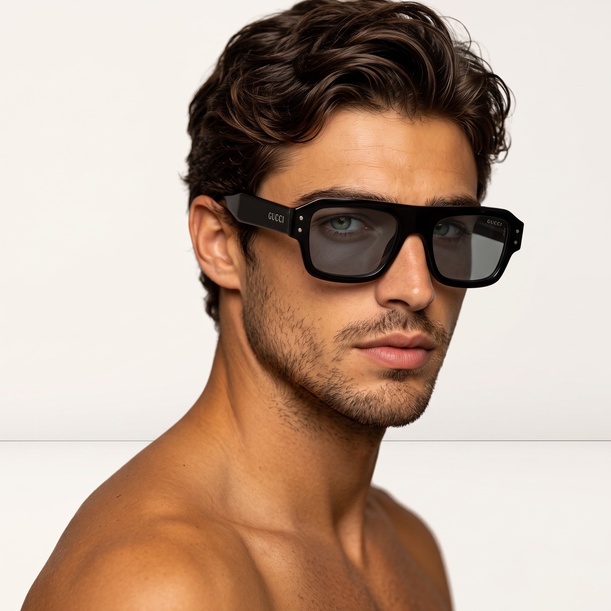 Close-up of man wearing black Gucci square sunglasses