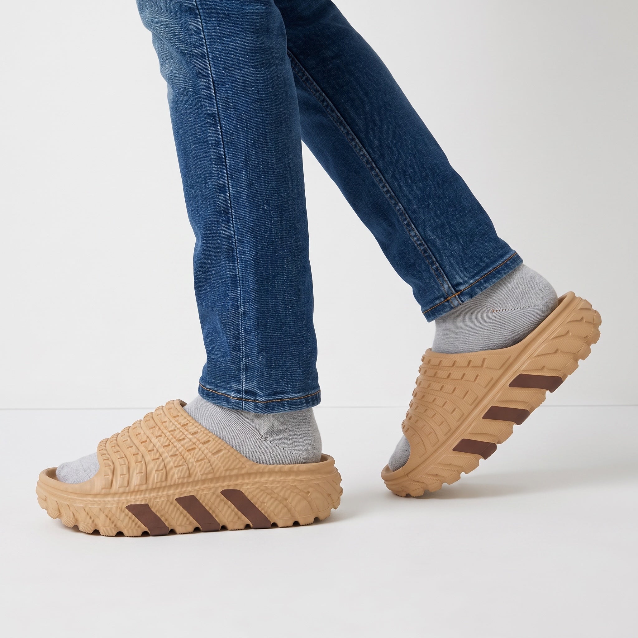 Beige chunky textured adidas-style slide sandal on foot