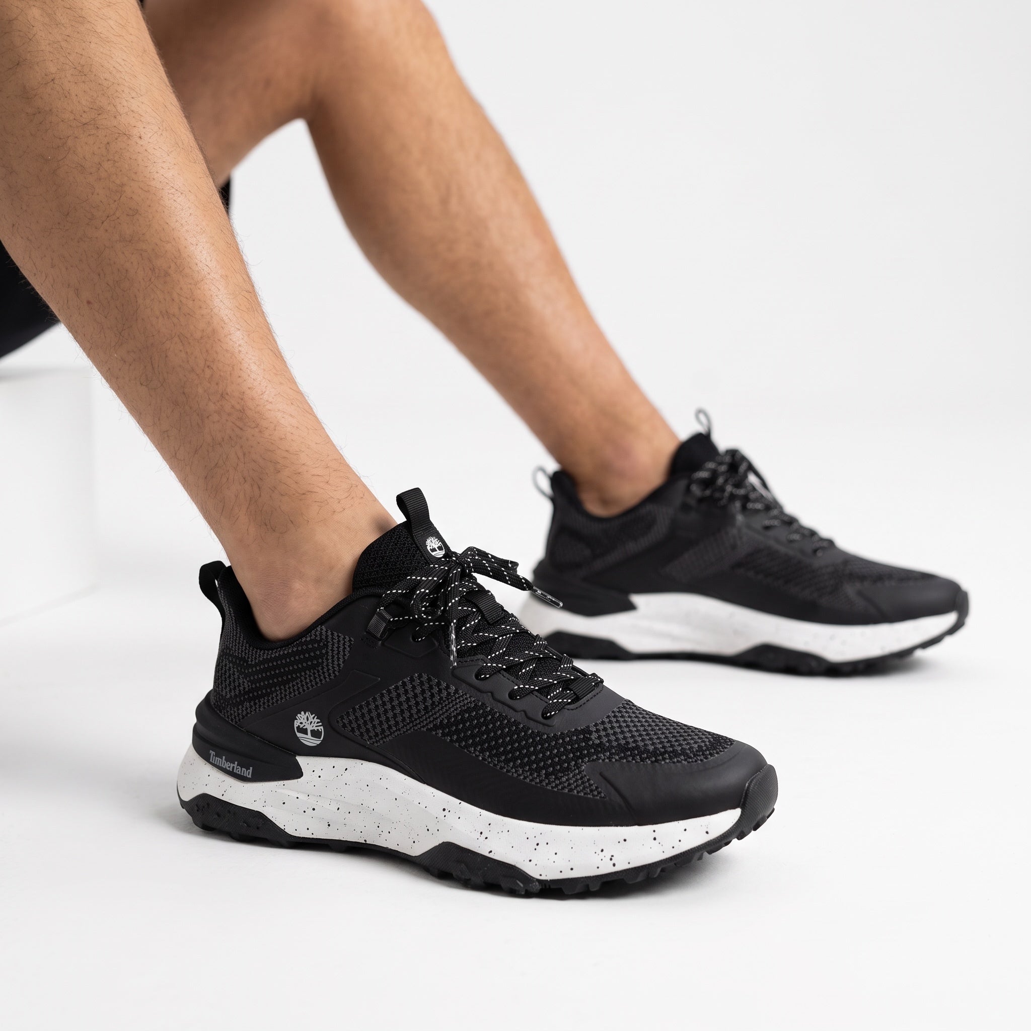 Black Timberland low-top trail sneakers with speckled white midsole
