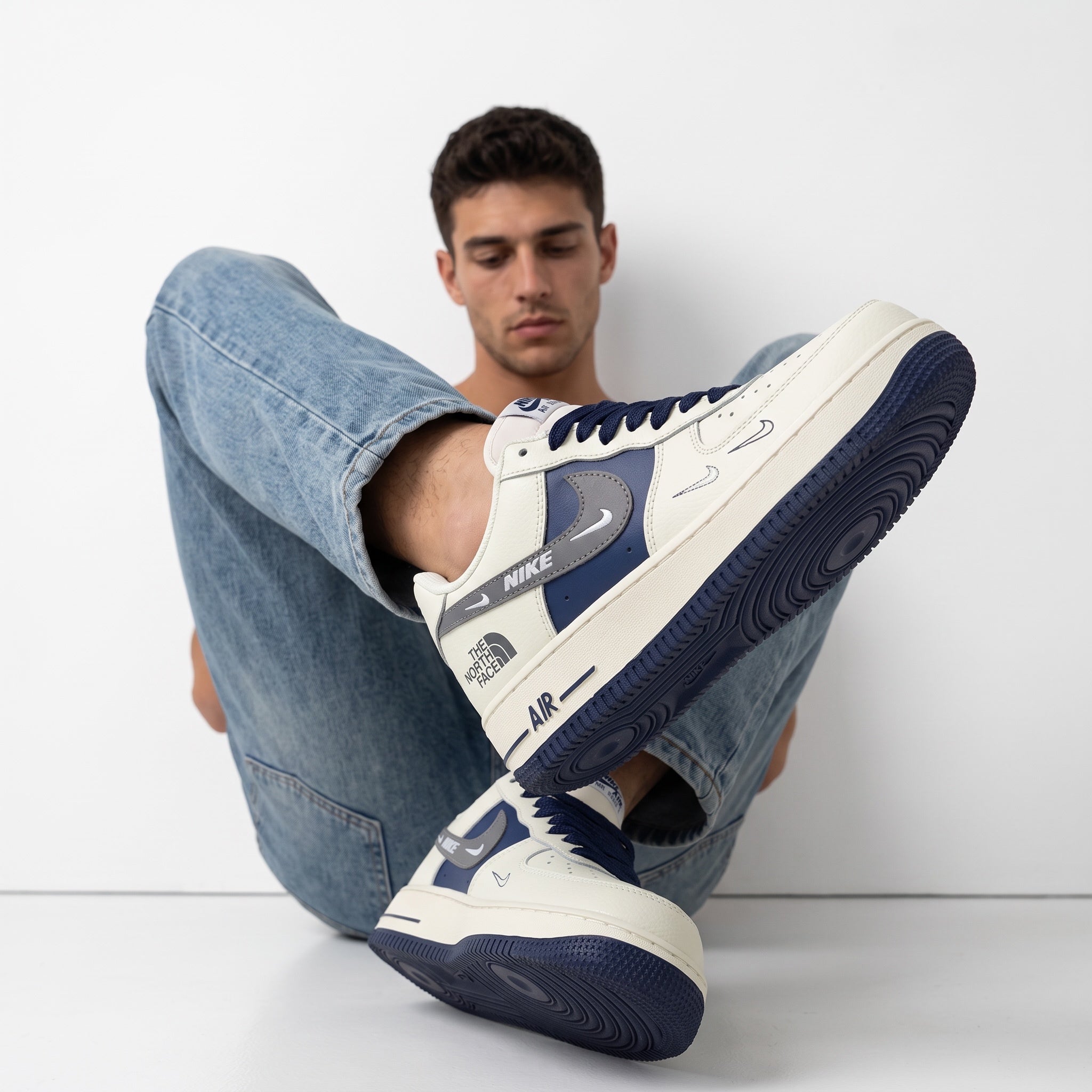 Nike Air Force 1 x The North Face cream and navy low-top sneaker on model