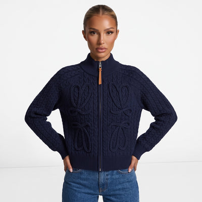 Navy cable-knit zip jacket with braided bow details and leather zipper pull