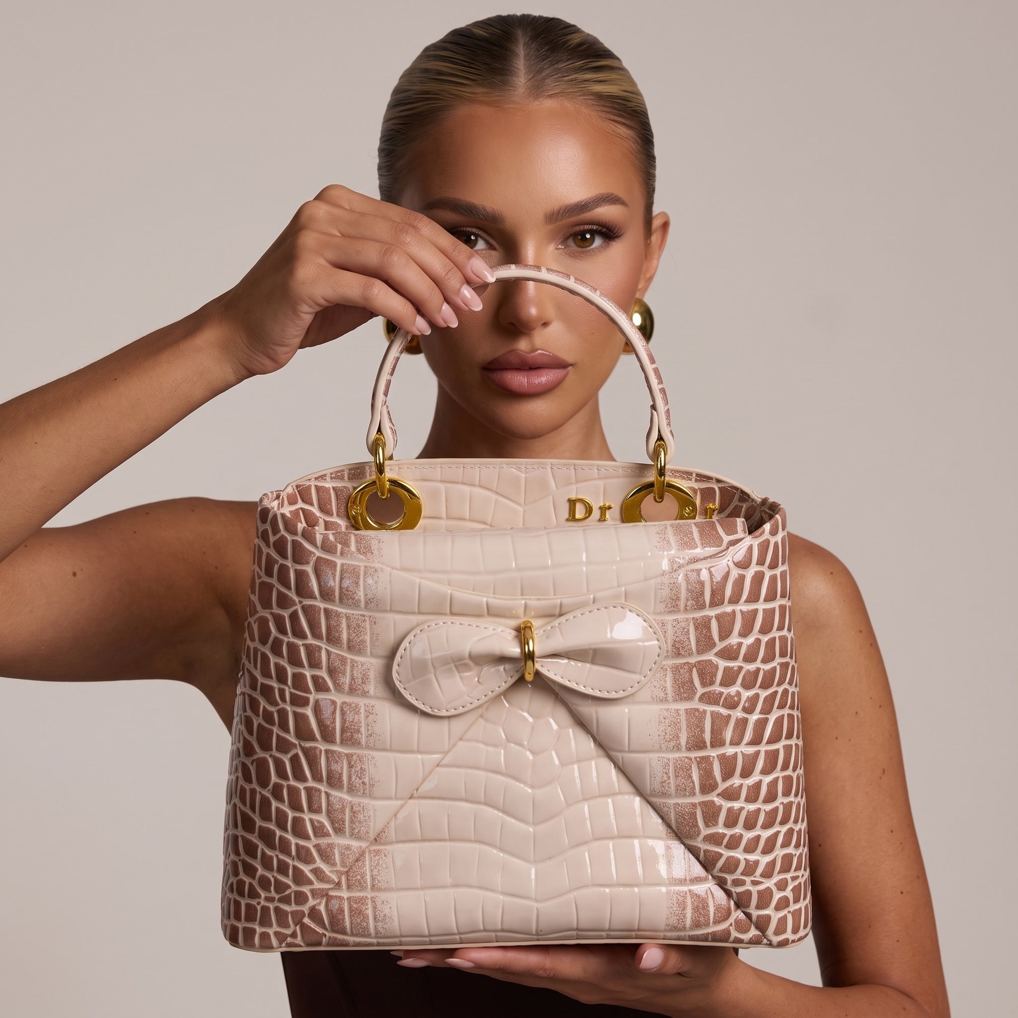 Dior Lady top-handle bag in nude croc-embossed finish with bow and gold rings
