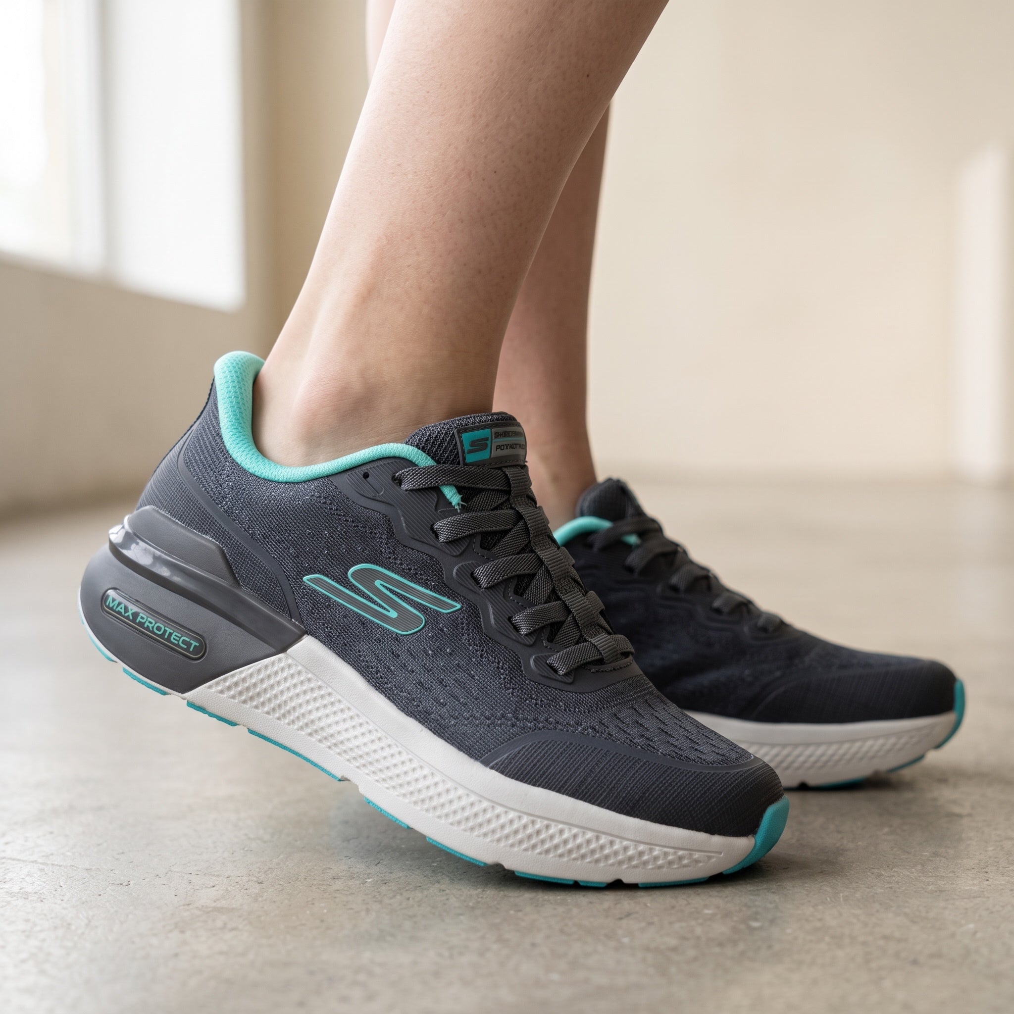 Grey Skechers sneakers with teal trim and visible Max Protect heel
