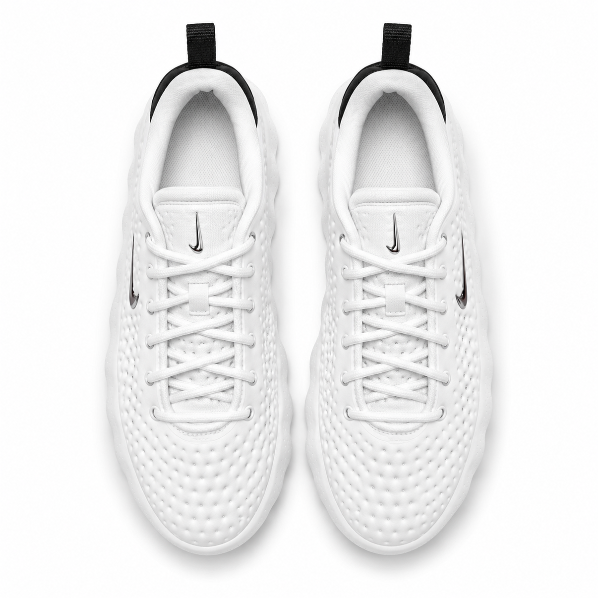 White Nike low-top perforated sneaker with black heel and podded sole