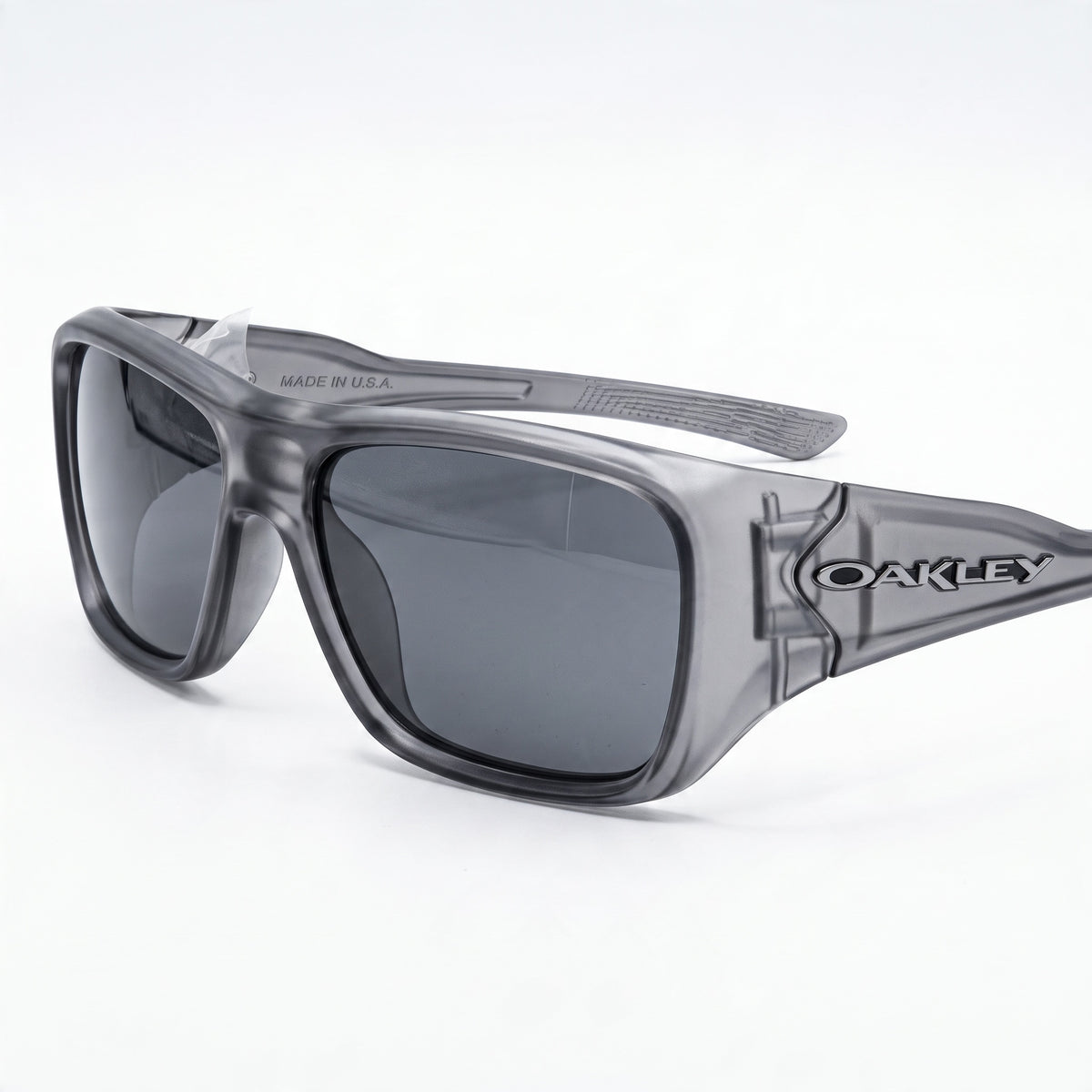 Oakley translucent smoke grey sunglasses with dark lenses showing Made in U.S.A. on temple