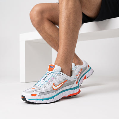 Nike P-6000 white sneakers with orange and teal accents