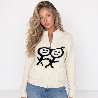 Cream zip knit sweater with black smiley motif and front pockets