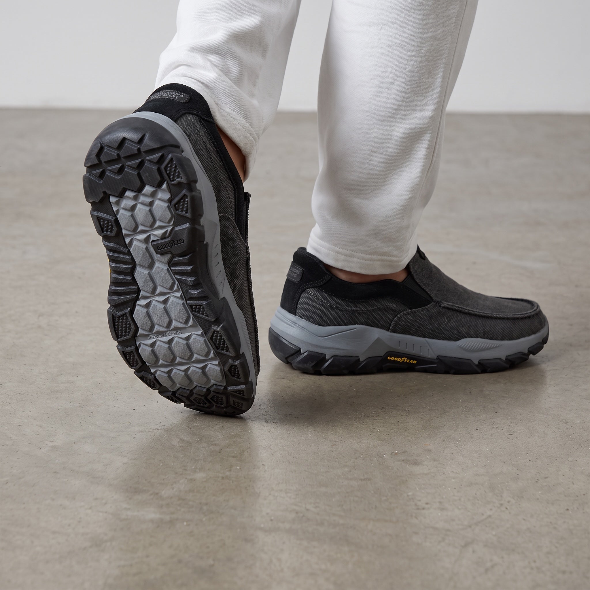 charcoal grey Skechers slip-on trainer with chunky grey lug sole and Goodyear logo